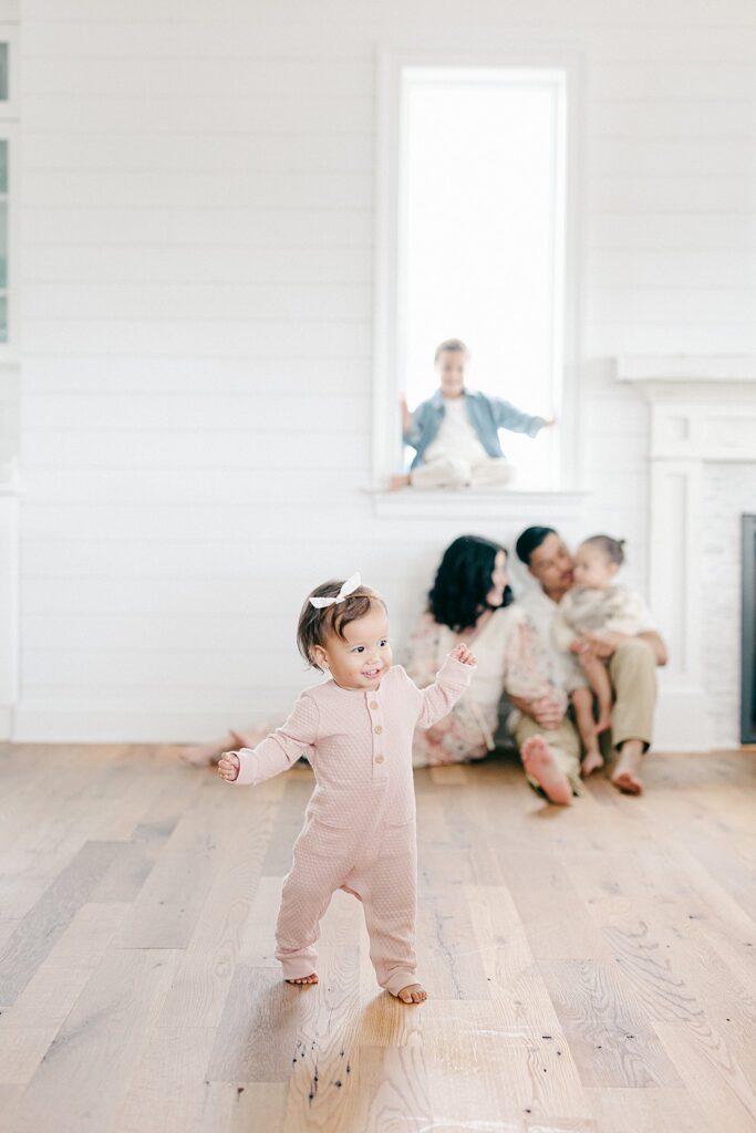 Candid in-home family photo with parents and three siblings during a relaxed lifestyle session in Port Saint Lucie