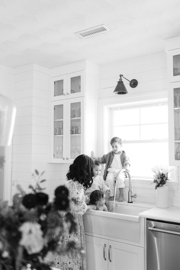 Candid in-home family photo with parents and three siblings during a relaxed lifestyle session in Port Saint Lucie