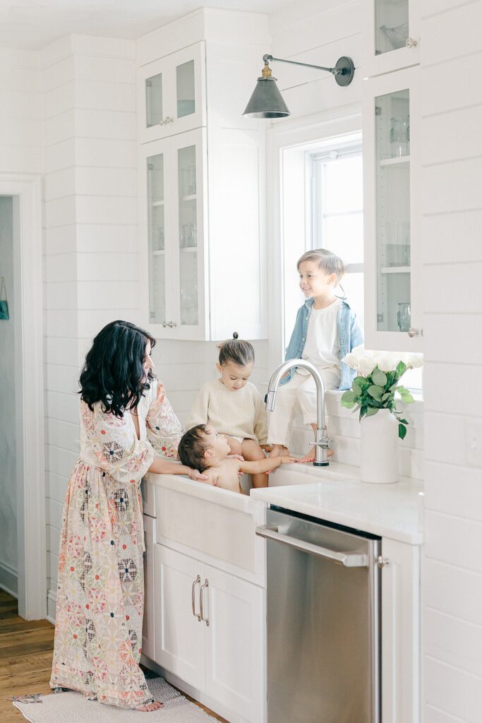 Candid in-home family photo with parents and three siblings during a relaxed lifestyle session in Port Saint Lucie