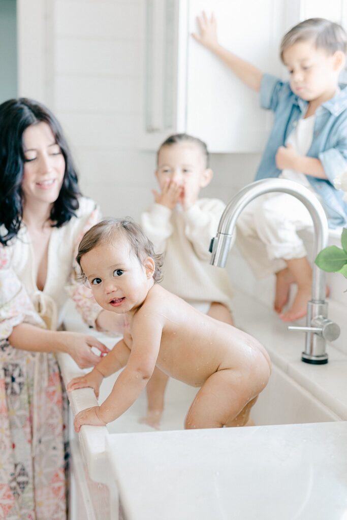 Candid in-home family photo with parents and three siblings during a relaxed lifestyle session in Port Saint Lucie