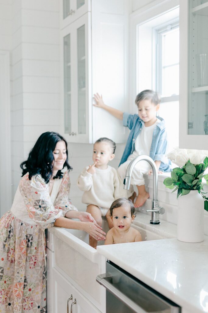 Candid in-home family photo with parents and three siblings during a relaxed lifestyle session in Port Saint Lucie