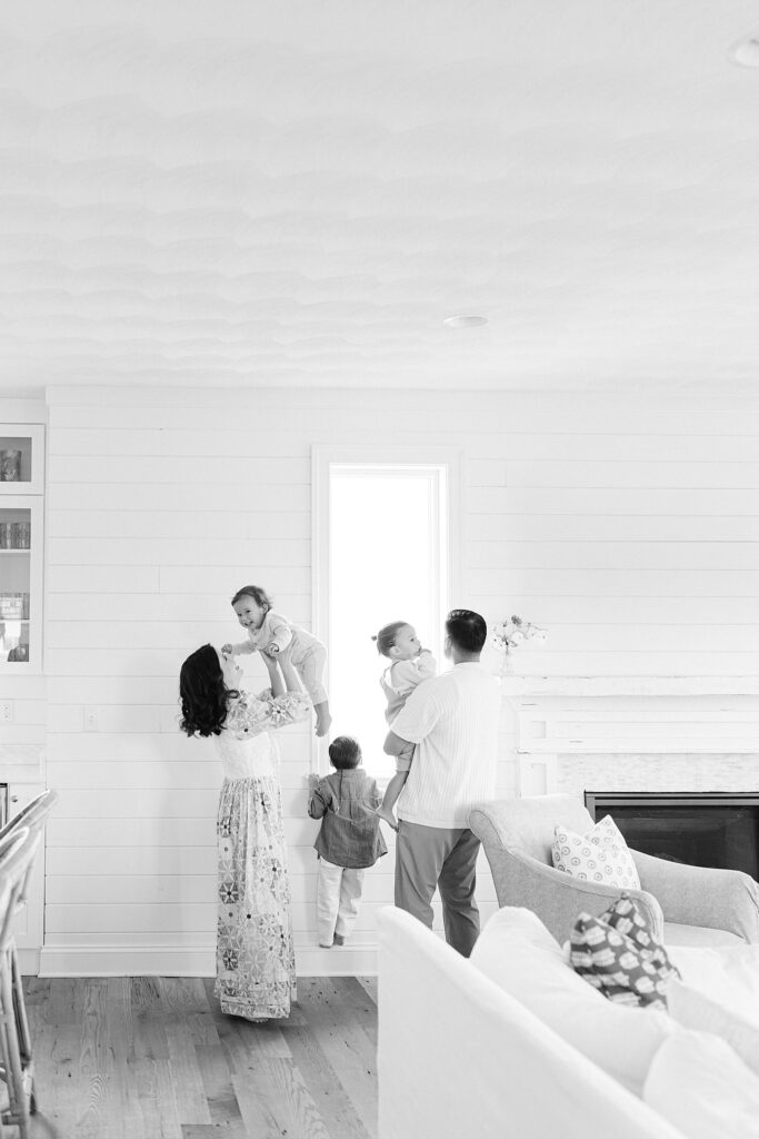 Candid in-home family photo with parents and three siblings during a relaxed lifestyle session in Port Saint Lucie