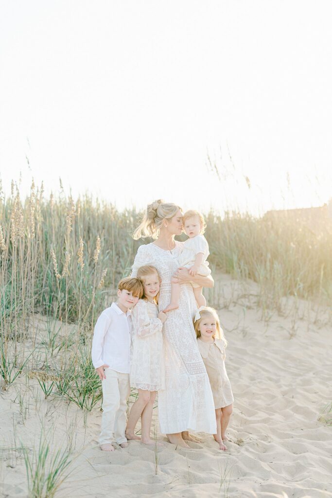 Mother and her three children during a golden hour beach session in Jupiter, Florida — captured by Port Saint Lucie family photographer known for stress-free, full-service portraits.