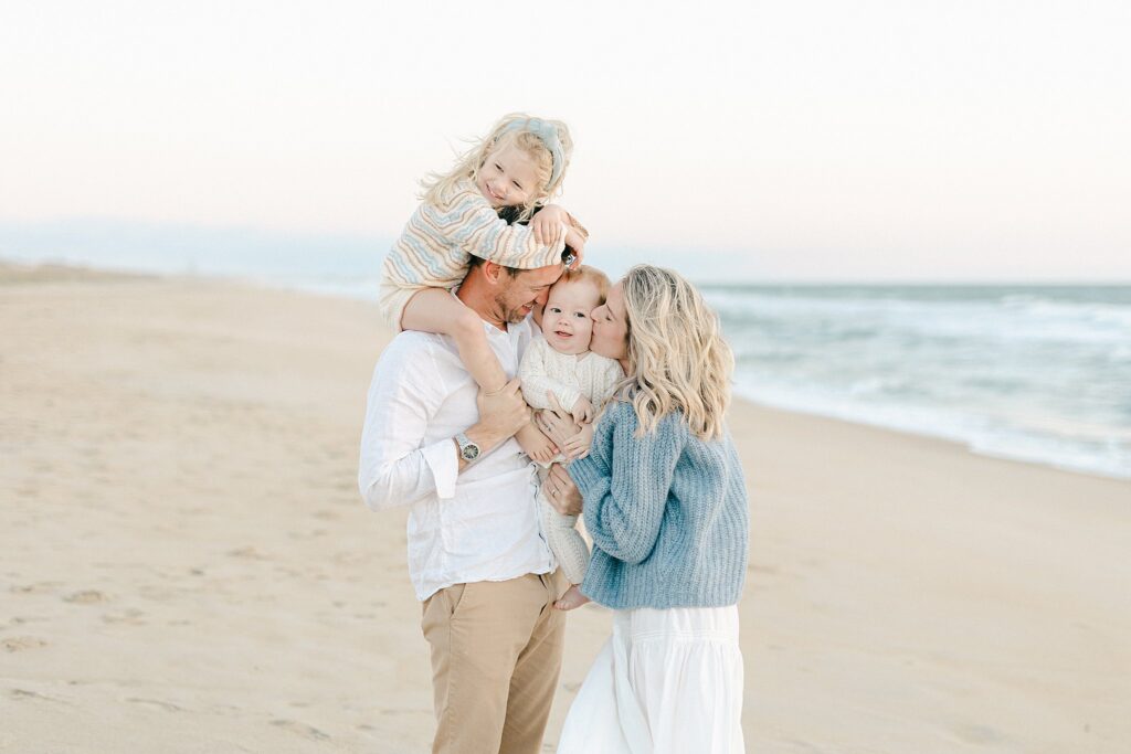 Relaxed and joyful beach family photo session with two young children, captured by a luxury family photographer in Palm Beach Gardens, Florida.